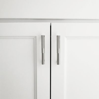 Hapny Sunburst 4" cabinet pull installed on white cabinet doors