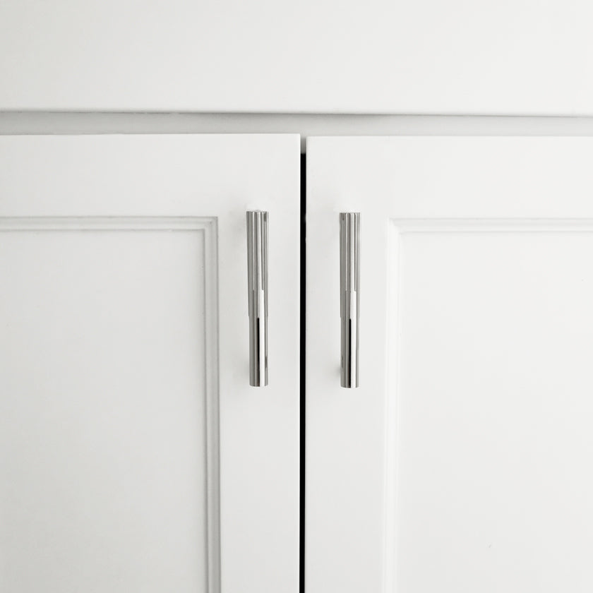 Hapny Sunburst 4" cabinet pull installed on white cabinet doors