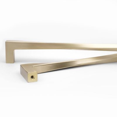 Satin Brass Appliance Pull and Knob with Twist on a Table