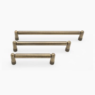 Set of three antique english cabinet handles on a white background
